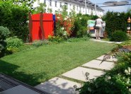 Der breite Plattenweg schützt den Grasbeleg bei Dauernutzung des Gartens.